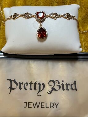 Pretty Bird Gold Necklace with Red Heart and Teardrop Stones